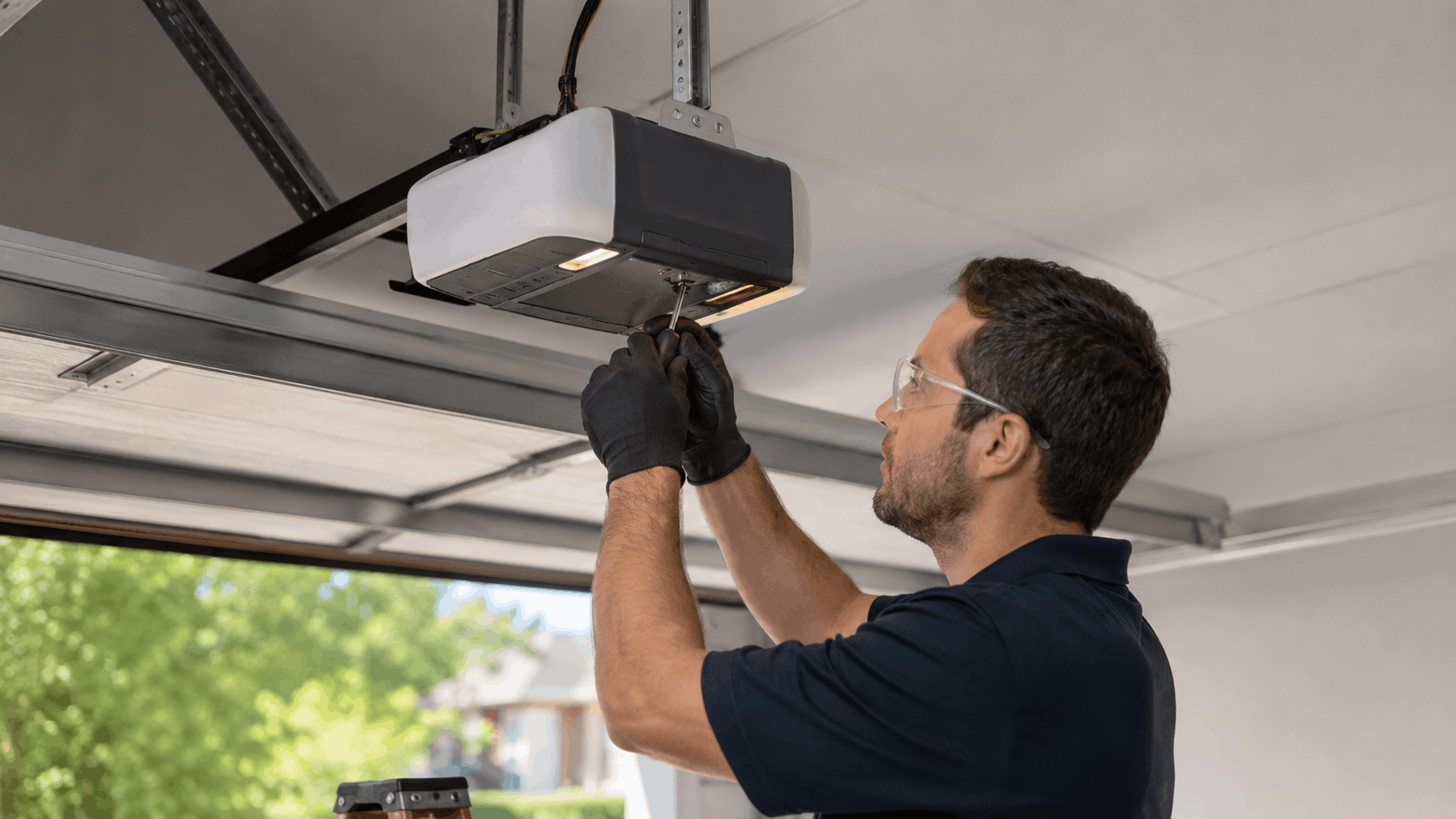 Technician installing Genie garage door opener motor unit in Irvine home garage