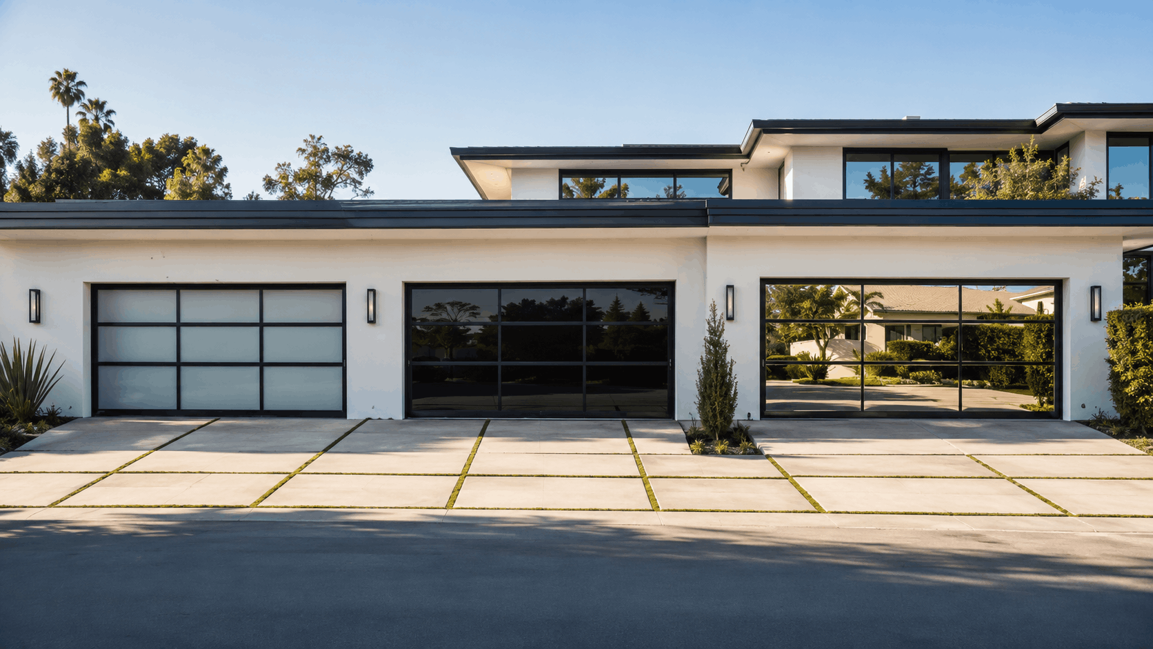 Modern luxury home with three black-framed glass garage doors in Irvine California