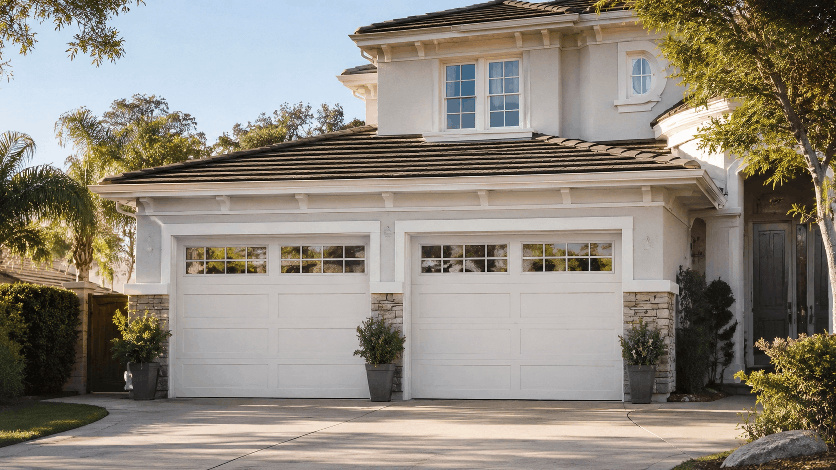 White double garage doors with windows on upscale Tustin Ranch Irvine home exterior