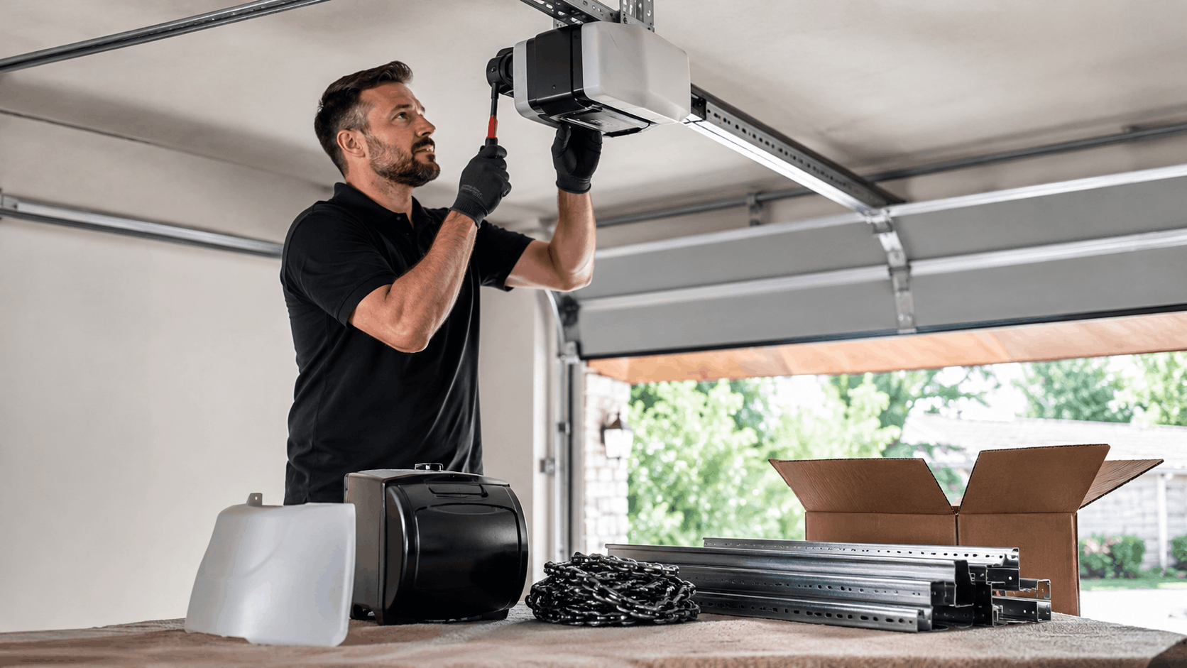 Technician installing garage door opener motor unit on ceiling rail in Irvine