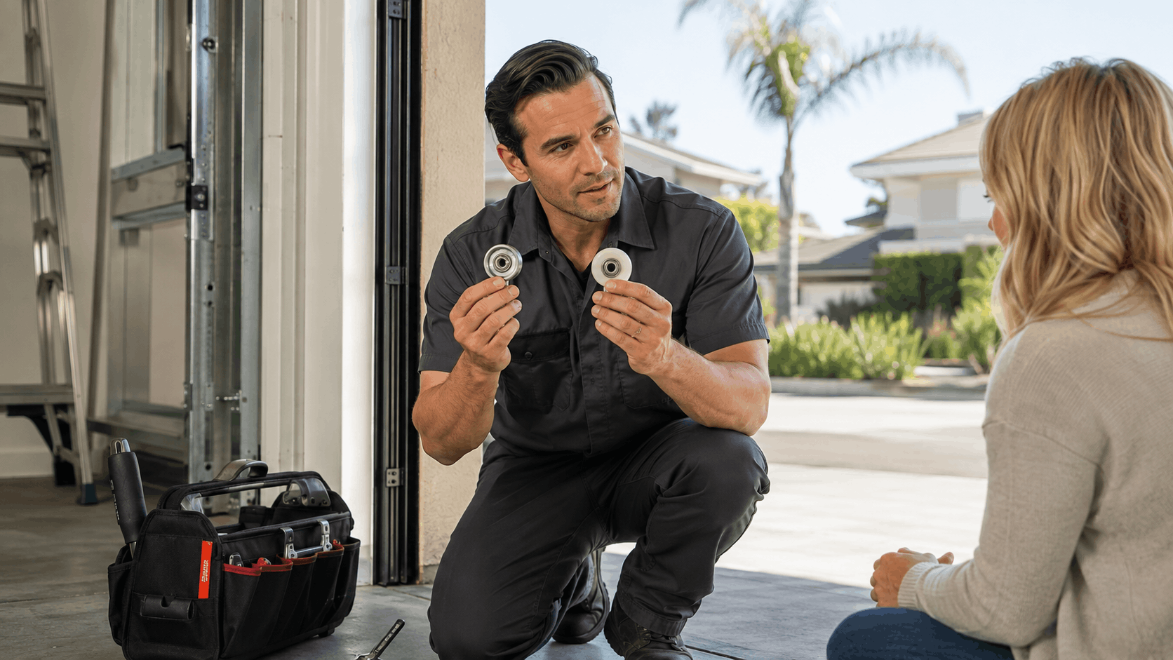 Garage door technician comparing nylon and steel rollers to homeowner in Irvine driveway