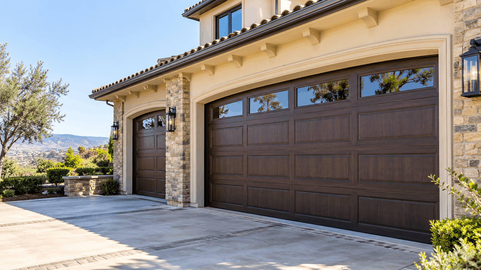Elegant wood-finish garage doors on luxury Irvine home with stone accents