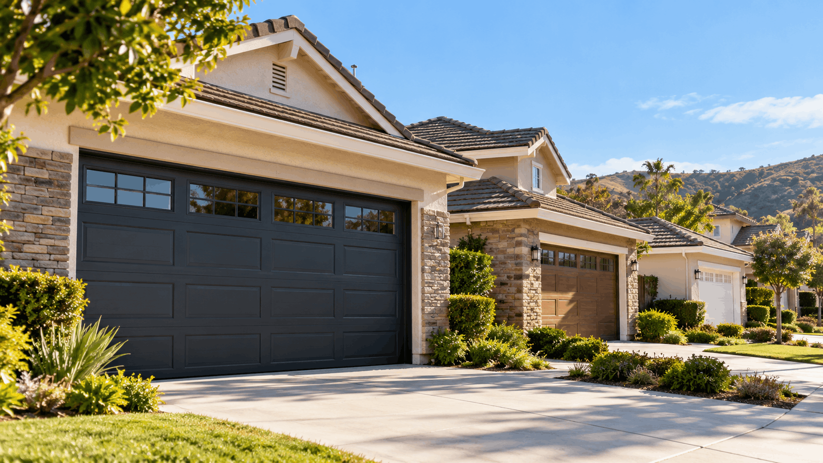 Irvine residential homes with dark charcoal and wood-tone garage doors and stone accents
