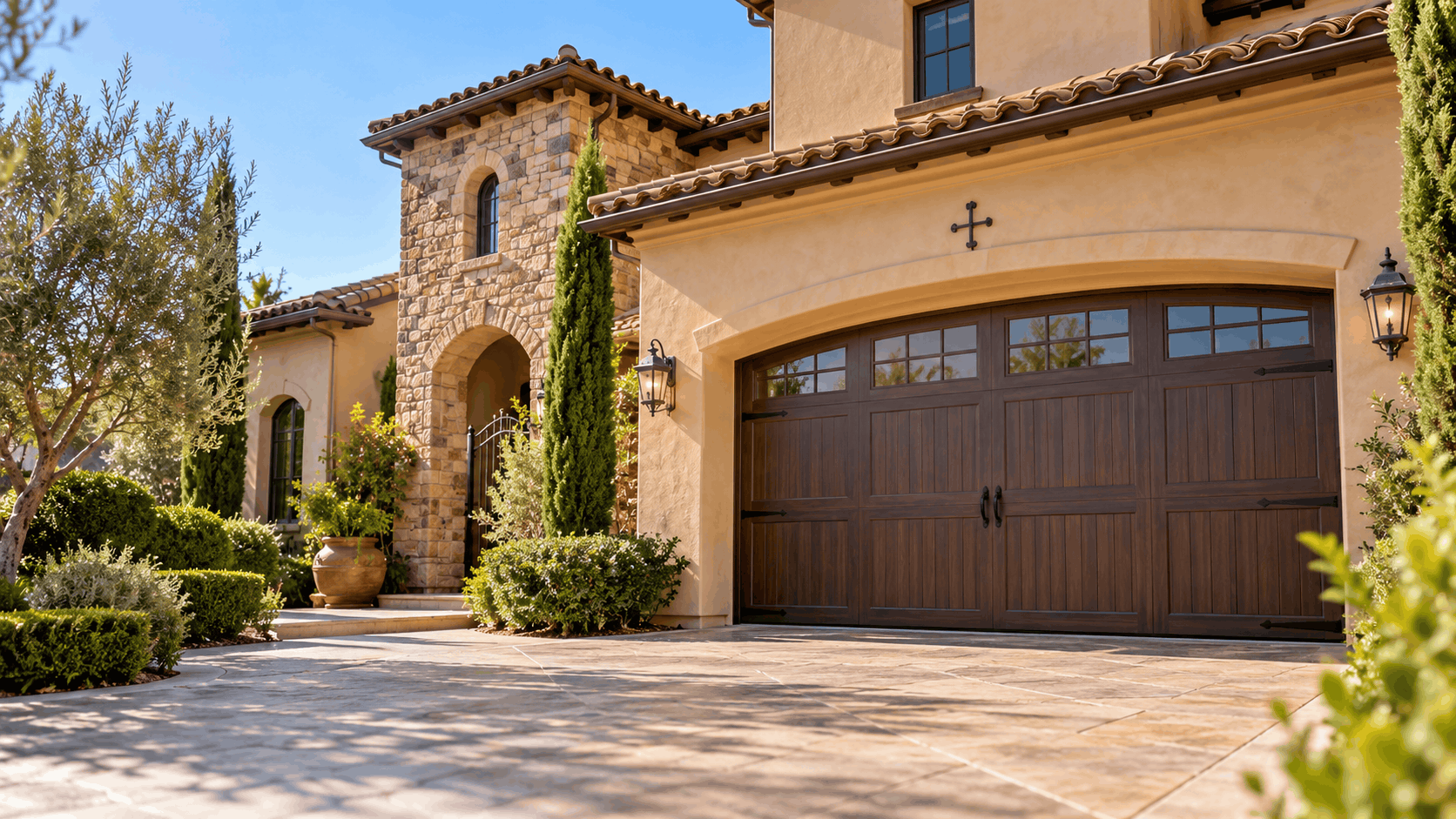 Tustin Ranch luxury home with brown wood garage door and Mediterranean architecture