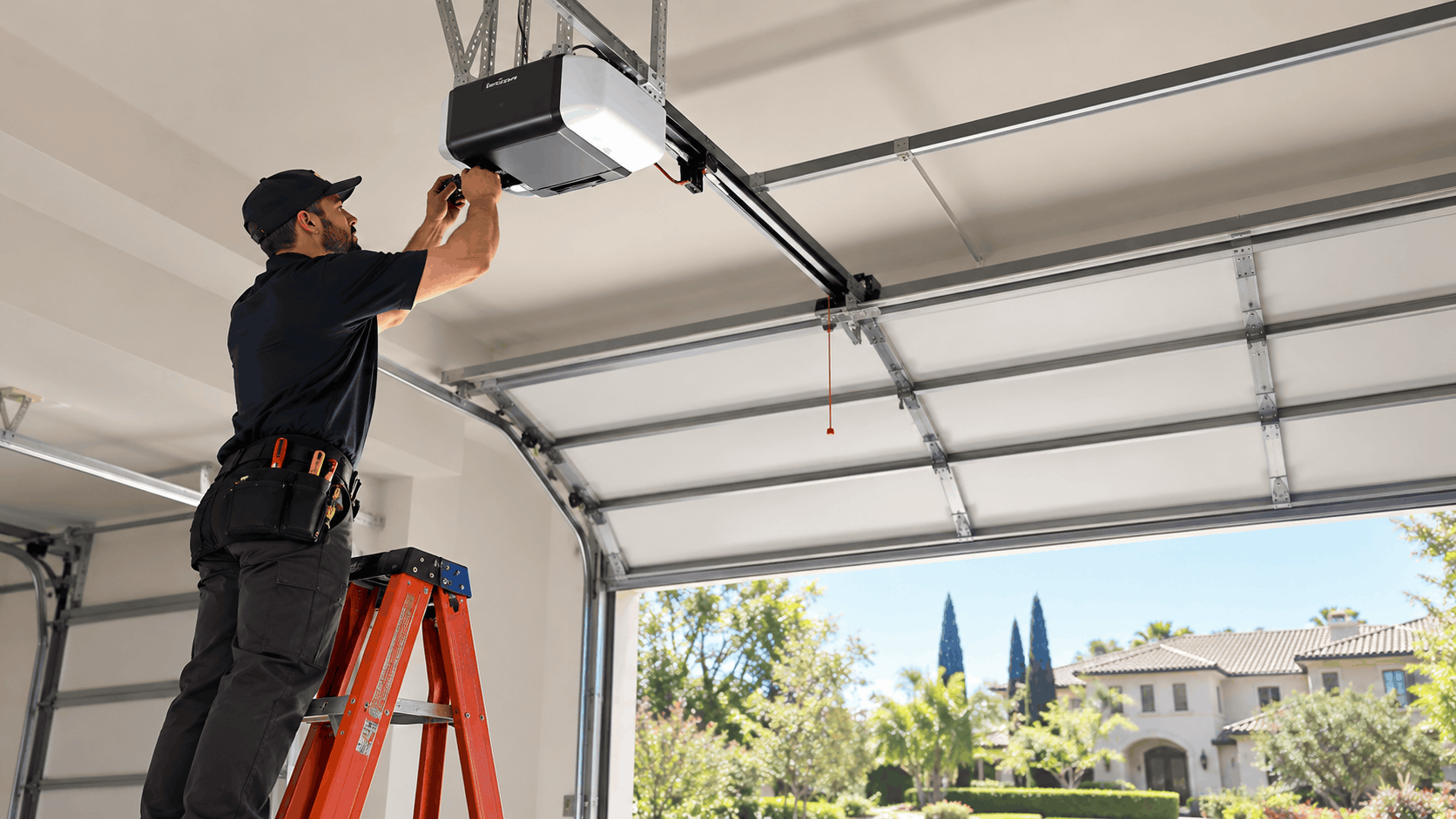 Technician installing garage door opener on ladder in Irvine North Tustin home